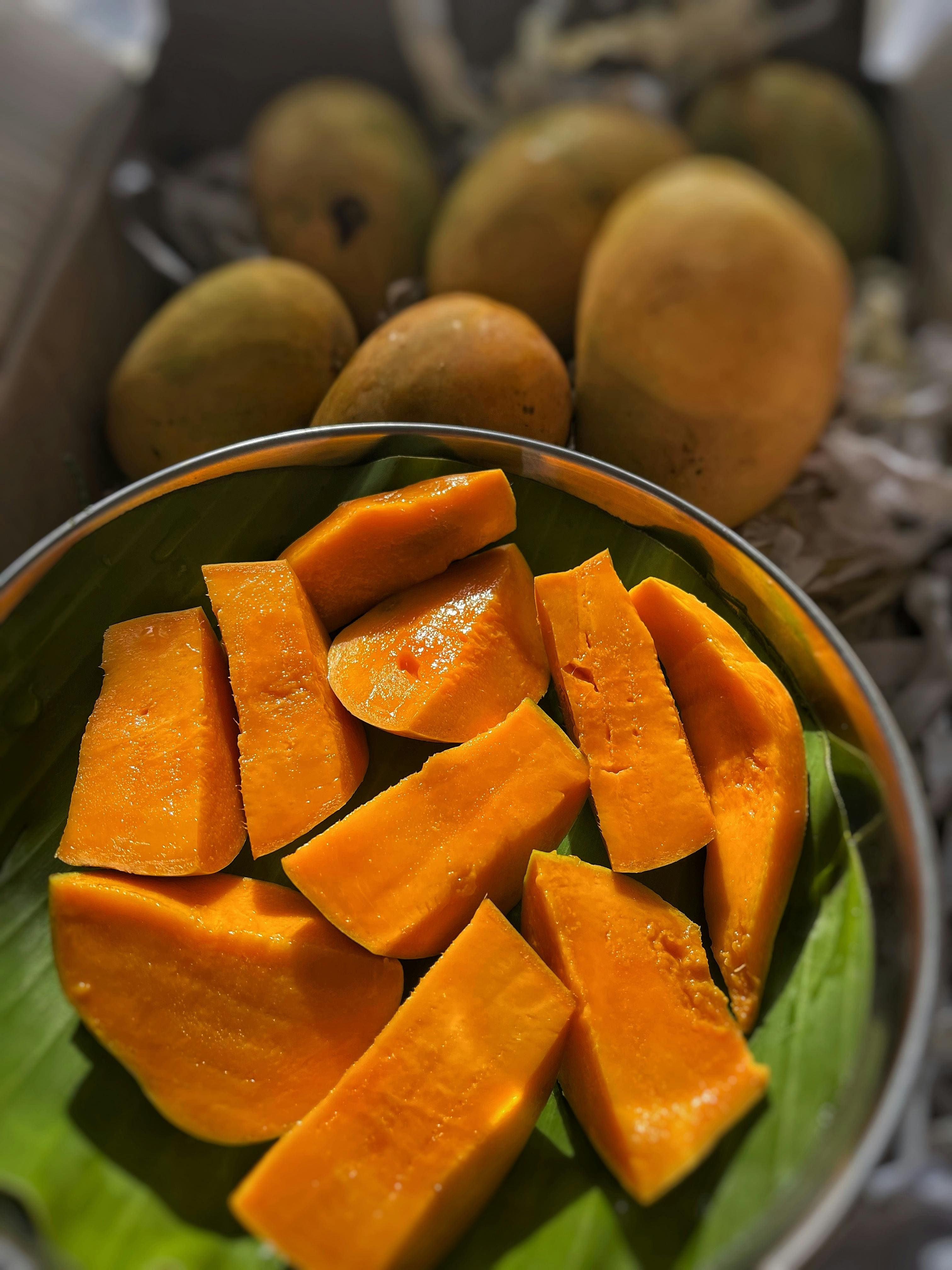 picture of a mango that is cut up and being hit by a ray of sunlight