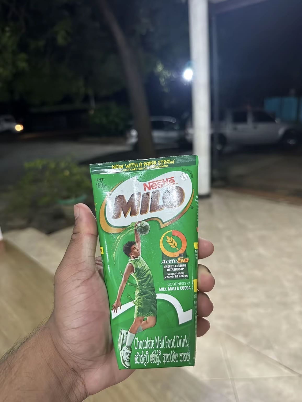 picture of a milo drink in hand ready to be consumed